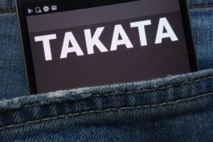 Image of a cell phone in a pocket with takata on the screen