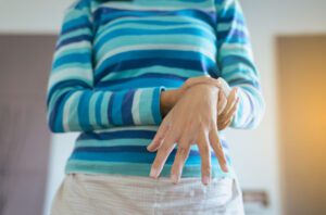 Image of woman holding her wrist