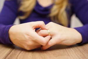 Image of a woman taking off her wedding ring