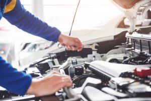 Image of mechanic in garage with a wrench