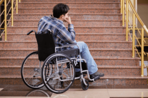 Image of person in wheelchair at the bottom of stairs