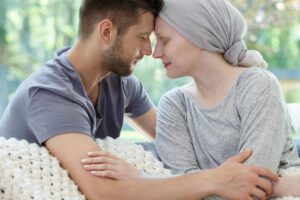 Image of woman with cancer cuddling man