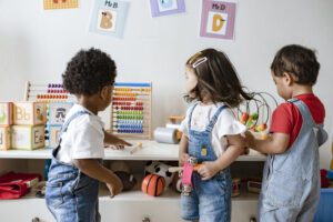 Image of preschoolers playing with toys in a classroom