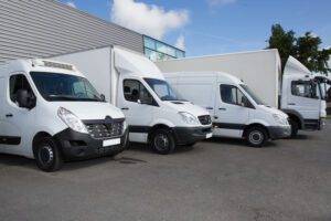 Image of moving vans and trucks parked in a lot