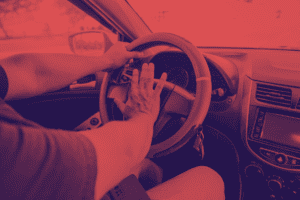 Image with a red overlay of person honking car horn