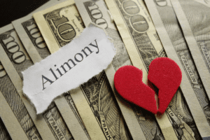 Image of money with alimony label and broken heart