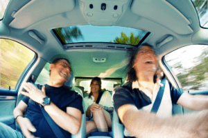 Image of happy people inside a vehicle