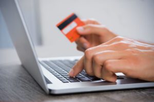 Image of person making an online payment on their laptop