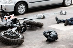 Image of crashed motorcycle with injured driver