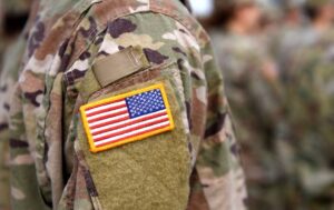 Image of military person in uniform with a flag patch on the sleeve