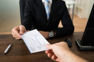 Image of two people exchanging a check