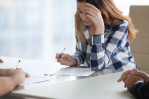 Image of woman signing a divorce decree