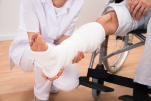 Image of medical professional and injured person in a leg cast