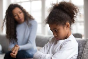 Woman talking to upset girl