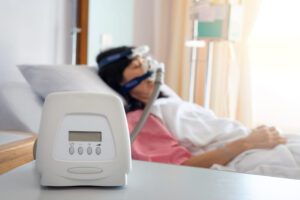 Image of a woman wearing a CPAP machine