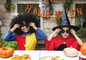 Image of children dressed up as a clown and a witch on halloween