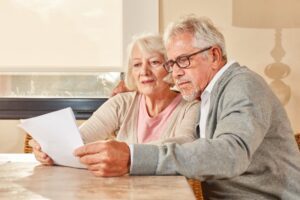 Image of elderly couple reading paperwork