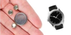 Image of button batteries in a hand with a watch nearby