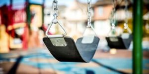 Image of empty swings on a playground