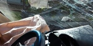 Image of a deployed airbag and broken windshield