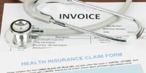 Image of Health Care Insurance Claim Form, invoice, and stethoscope