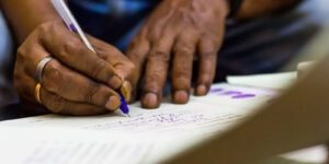 Image of person filling out paperwork