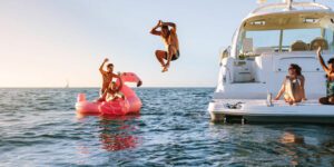 Image of people having fun on a boat and in the water