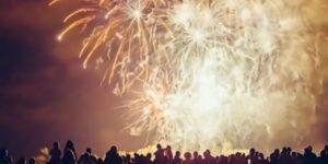 Image of crowd watching bright fireworks