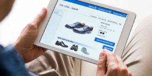 Image of man shopping online for black dress shoes