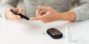 Image of woman testing her blood sugar