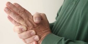 Image of older person rubbing their hands together