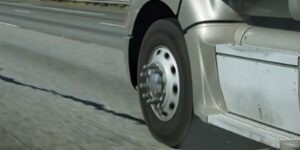 Close up image of semi truck tire and wheel well