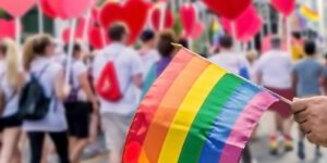 Image of a pride flag and hearts at a pride parade