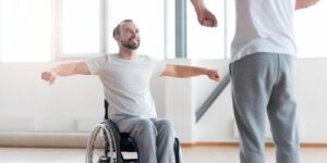 Image of man in a wheelchair performing physical therapy motions