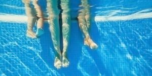 Underwater image of legs in a pool