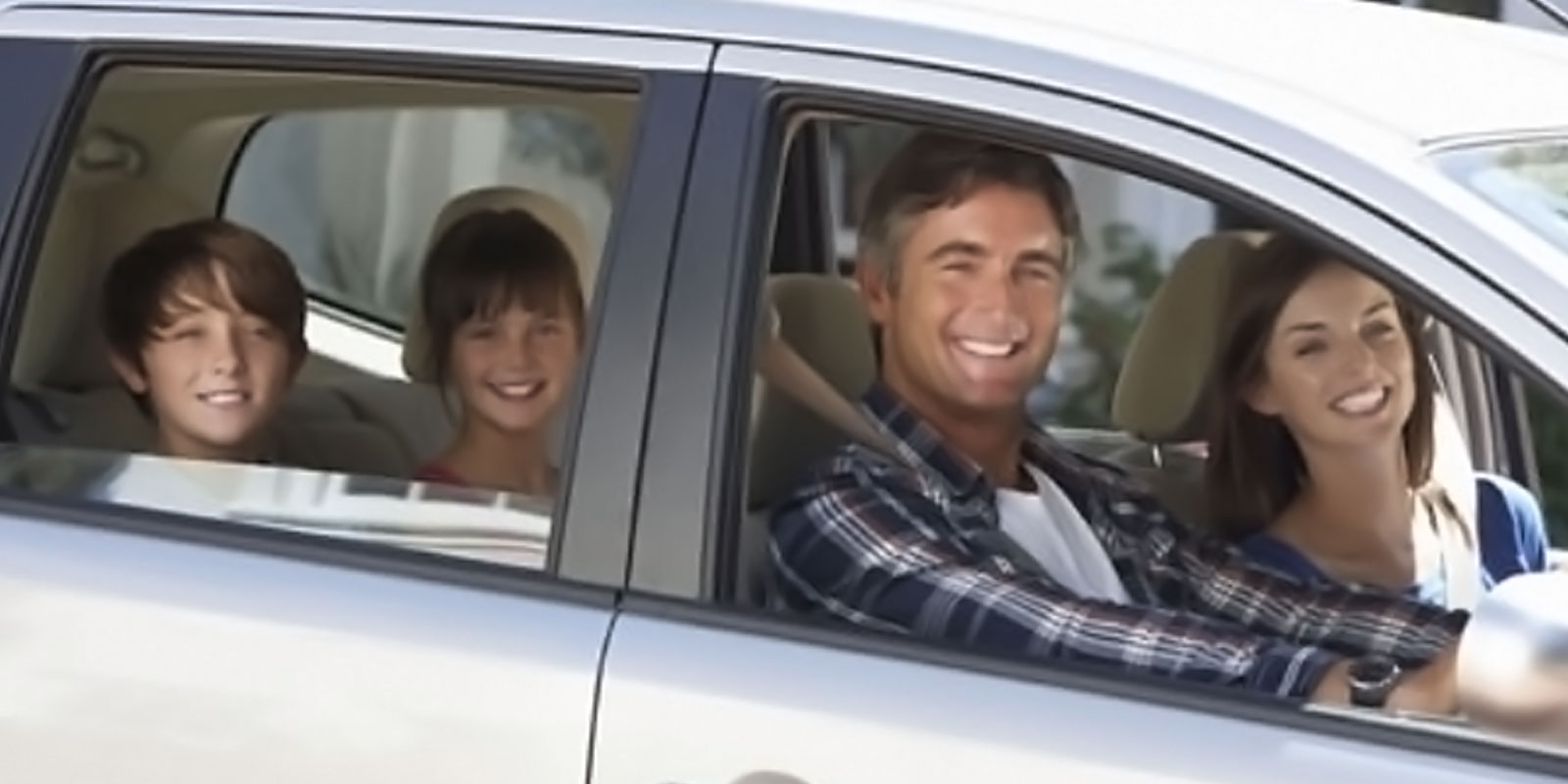 Image of happy family inside a vehicle