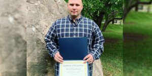 Image of man with certificate of completion for drilling fluids engineering