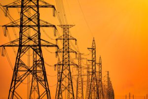 Image of high voltage powerlines with an orange sky