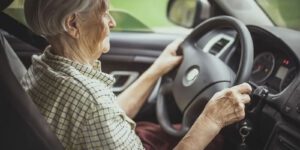 Image of an elderly woman driving a car