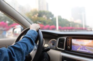 Image of a person behind the wheel of a car