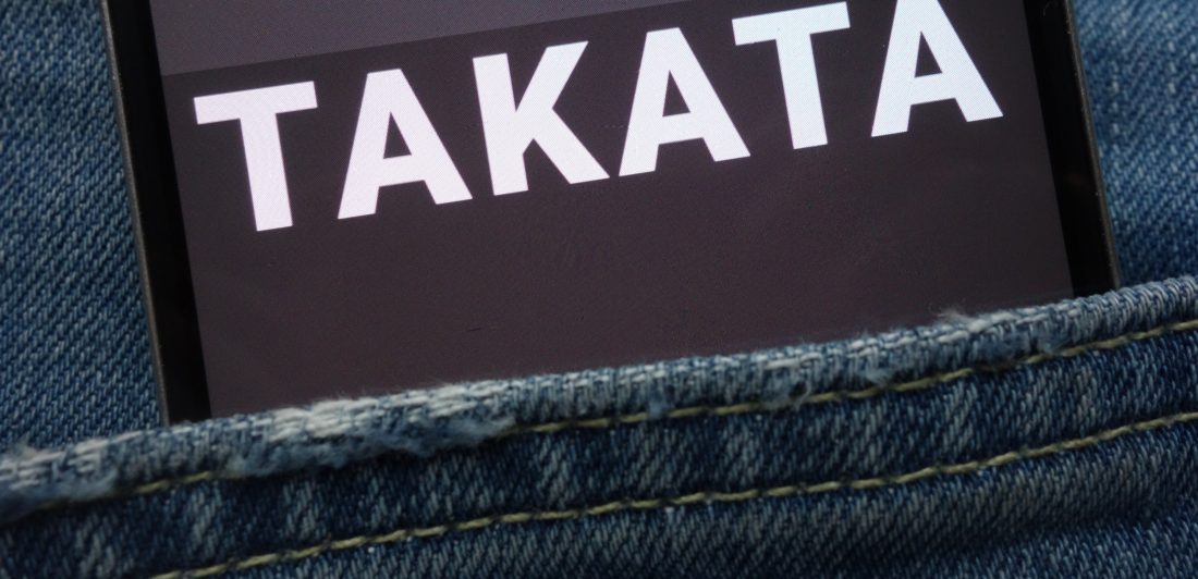 Image of a cell phone in a pocket with takata on the screen