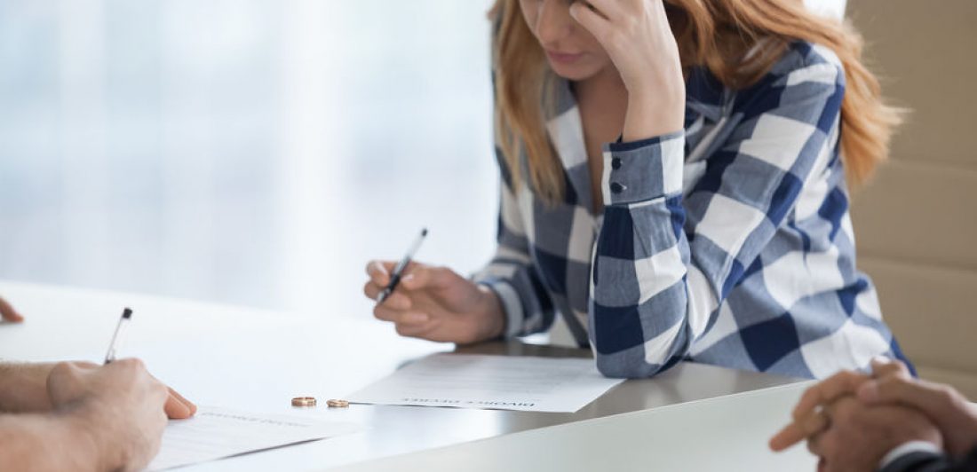 Image of woman signing a divorce decree