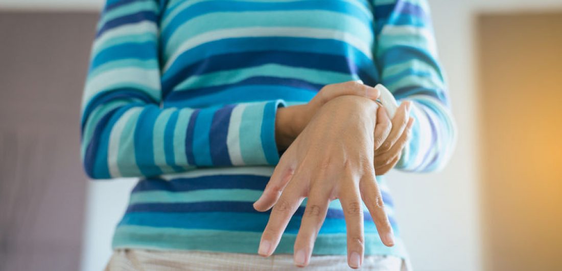 Image of woman holding her wrist