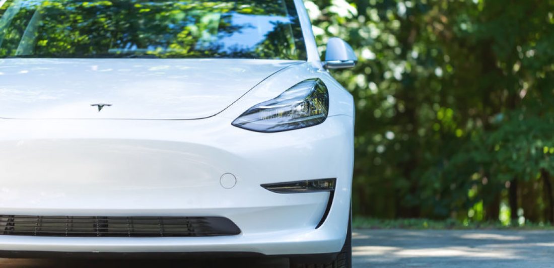 Image of the front of a white Tesla car