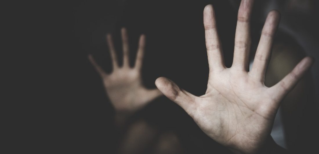 Image of two hands held up in the dark