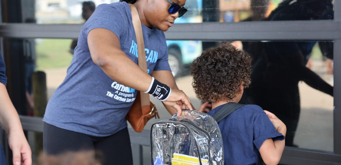 2024-Waco-Backpack-Giveaway-Porsche-Placing-Backpack-on-Boys-Back-7-scaled