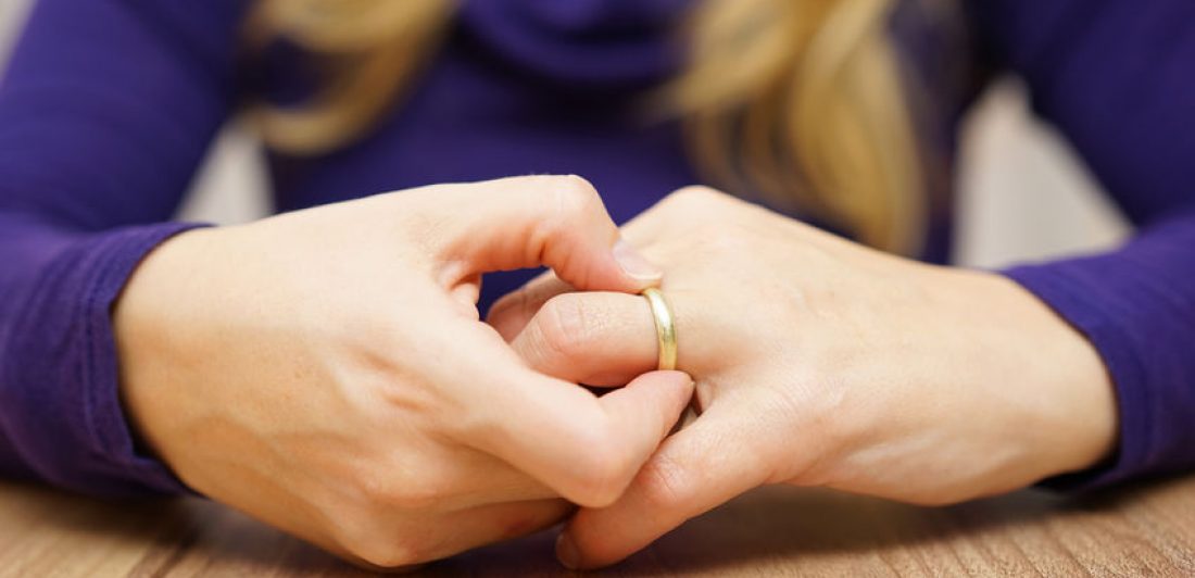 Image of a woman taking off her wedding ring