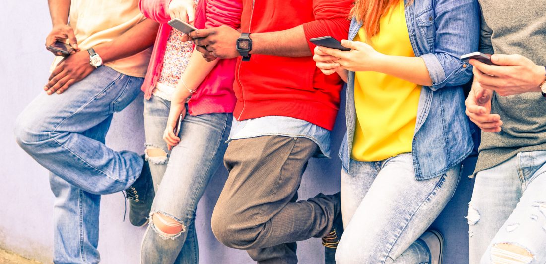 Image of teens using cell phones