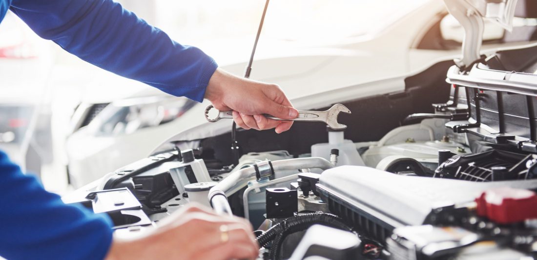 Image of mechanic in garage with a wrench