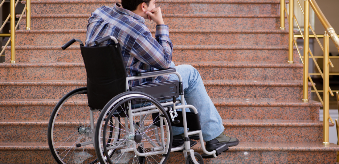 Image of person in wheelchair at the bottom of stairs